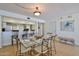 Dining area featuring glass table, 6 chairs, pendant lighting and decorative painting on the wall at 3855 S Atlantic Ave # 1405, Daytona Beach, FL 32118