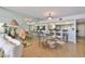 Dining area adjacent to living room, a mirror wall, and open access to the kitchen and bar at 3855 S Atlantic Ave # 1405, Daytona Beach, FL 32118