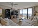 Comfortable living room with ocean view, built-in shelving and sliding doors to an oceanfront balcony at 3855 S Atlantic Ave # 1405, Daytona Beach, FL 32118