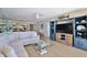 Comfortable living room with built-in shelving, TV, ceiling fan and view into dining area at 3855 S Atlantic Ave # 1405, Daytona Beach, FL 32118