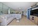 Spacious living area with comfortable sofa, adjacent dining area, and decorative mirror wall at 3855 S Atlantic Ave # 1405, Daytona Beach, FL 32118