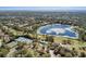 Aerial view highlighting the community's amenities: tennis courts, pool, and clubhouse amidst a beautiful golf course setting at 397 Quail Hill Dr, Debary, FL 32713