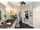 Bathroom with double sinks and black tile flooring at 397 Quail Hill Dr, Debary, FL 32713