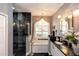 Luxurious bathroom featuring a glass shower, soaking tub, and elegant chandelier lighting at 397 Quail Hill Dr, Debary, FL 32713