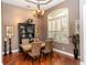 Formal dining room featuring a wooden table, elegant chandelier, and shuttered windows at 397 Quail Hill Dr, Debary, FL 32713