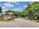 The welcoming community entrance features lush landscaping and a grand entry gate at 397 Quail Hill Dr, Debary, FL 32713