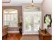 Warm and inviting foyer with hardwood floors, large windows, and stylish decor at 397 Quail Hill Dr, Debary, FL 32713