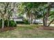 This home features a beautifully maintained front yard, enhanced by mature trees, shrubbery, and manicured grass at 397 Quail Hill Dr, Debary, FL 32713