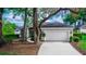 View of the home's exterior showcasing the large garage and driveway at 397 Quail Hill Dr, Debary, FL 32713