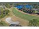Scenic aerial view of the lush golf course and serene lake offering beautiful views and outdoor recreation at 397 Quail Hill Dr, Debary, FL 32713
