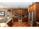 Traditional kitchen with stainless appliances, granite counters and wood cabinets at 397 Quail Hill Dr, Debary, FL 32713