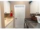 Functional laundry room featuring a sink, storage cabinets, and a modern washer and dryer at 397 Quail Hill Dr, Debary, FL 32713