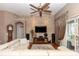 Spacious living room with a stone accent wall, large sofa, and sliding glass doors at 397 Quail Hill Dr, Debary, FL 32713