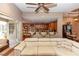 Open-concept living area, with seating at the bar area and sliding glass doors to the patio at 397 Quail Hill Dr, Debary, FL 32713