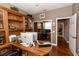 Spacious home office with custom wooden shelves, large desk, and two workstations at 397 Quail Hill Dr, Debary, FL 32713