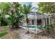 The enclosed pool is landscaped with lush greenery, creating a private backyard oasis at 397 Quail Hill Dr, Debary, FL 32713