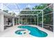 Relaxing screened-in pool area features a spa and plenty of room for entertaining and enjoying the Florida lifestyle at 397 Quail Hill Dr, Debary, FL 32713