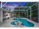 Sparkling pool under screened enclosure surrounded by lush landscaping at 397 Quail Hill Dr, Debary, FL 32713