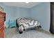 Calm blue bedroom featuring carpeted floors and complemented by wood furnishings at 416 N Blue Lake Ter, Deland, FL 32724