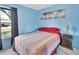 Sunlit bedroom with soft blue walls, complemented by bright furniture and a window view at 416 N Blue Lake Ter, Deland, FL 32724