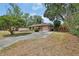 Cozy single-Gathering home with a spacious driveway and mature trees providing shade and curb appeal at 416 N Blue Lake Ter, Deland, FL 32724