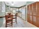 Cozy kitchen with a dining table, white cabinetry, and tile flooring, perfect for casual meals at 416 N Blue Lake Ter, Deland, FL 32724