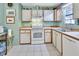Bright kitchen featuring white appliances, ample counter space, and lots of storage with natural light at 416 N Blue Lake Ter, Deland, FL 32724