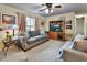 Bright living room featuring neutral tones, cozy seating, and large window allowing for plenty of natural light at 416 N Blue Lake Ter, Deland, FL 32724
