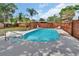 Sparkling blue swimming pool in a private backyard oasis with lounge chairs and a wooden fence at 416 N Blue Lake Ter, Deland, FL 32724