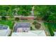 Aerial view of the landscaped backyard with a screened patio area and brick wall at 470 Foxhill Dr, Debary, FL 32713