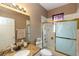Bathroom featuring granite counters, framed mirror, and shower with ornate doors at 470 Foxhill Dr, Debary, FL 32713