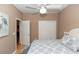 Bright bedroom with a ceiling fan, closet, and a bed with patterned blue and white linens at 470 Foxhill Dr, Debary, FL 32713