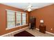 Bedroom with a large window, ceiling fan, wood floors, and a small wooden desk at 470 Foxhill Dr, Debary, FL 32713