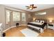 Calm main bedroom with large windows, a ceiling fan, and hardwood floors at 470 Foxhill Dr, Debary, FL 32713