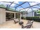 Screened patio with cozy outdoor seating and a view of the blue sky with clouds at 470 Foxhill Dr, Debary, FL 32713