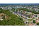 A beautiful neighborhood featuring water access, mature tree cover, and meticulously landscaped homes; as seen from a high aerial view at 5463 Carmody Lake Dr, Port Orange, FL 32128