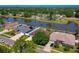 A high aerial view showcases the neighborhood with pond access and lush tree cover, with homes nestled among mature landscaping at 5463 Carmody Lake Dr, Port Orange, FL 32128