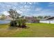 Landscaped backyard with paver patio and trees at 5463 Carmody Lake Dr, Port Orange, FL 32128