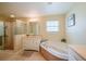 Bathroom showcasing a garden tub, separate shower, and dual sink vanity at 5463 Carmody Lake Dr, Port Orange, FL 32128