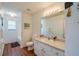 Bathroom with single sink vanity, mirror, and shower-tub combo at 5463 Carmody Lake Dr, Port Orange, FL 32128