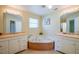 Bathroom featuring dual vanities, a garden tub, and natural light at 5463 Carmody Lake Dr, Port Orange, FL 32128
