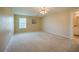 Spacious primary bedroom with a window allowing ample natural light and a ceiling fan at 5463 Carmody Lake Dr, Port Orange, FL 32128