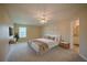 Comfortable bedroom with a ceiling fan, neutral tones, and natural light from the window at 5463 Carmody Lake Dr, Port Orange, FL 32128