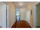 Hallway with hardwood floors and a view into the living room, creating an inviting entrance at 5463 Carmody Lake Dr, Port Orange, FL 32128