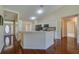 Open-concept kitchen with a breakfast bar, stainless appliances and wood flooring at 5463 Carmody Lake Dr, Port Orange, FL 32128