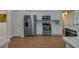 Modern kitchen with stainless steel appliances, white cabinets, and wood-look floors at 5463 Carmody Lake Dr, Port Orange, FL 32128