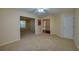 Bright living room featuring neutral carpet, ceiling fan and entryways to other rooms of the home at 5463 Carmody Lake Dr, Port Orange, FL 32128