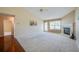 Bright living room featuring vaulted ceiling, fireplace, and natural light at 5463 Carmody Lake Dr, Port Orange, FL 32128