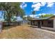 Expansive backyard with mature trees, providing ample shade and privacy, enclosed by a wooden fence at 5788 Devon St, Port Orange, FL 32127