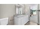 Bright bathroom with double sink vanity featuring granite counters, and direct access to a screened patio at 5788 Devon St, Port Orange, FL 32127